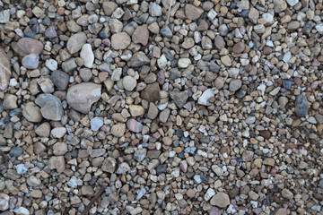 Closeup of pebbles on the ground. The natural art background. 