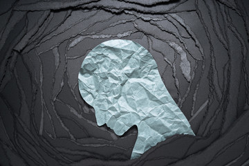 Silhouette of depressed and anxiety person head. Negative emotion image. Person head shaped paper...