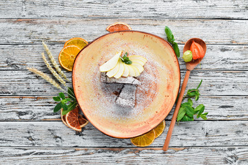 Chocolate Brownies Dessert with Pear. Dessert, pastry. On a wooden background. Top view. Free copy space.