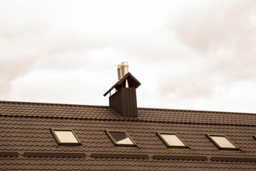 Metal roof with windows against the sky