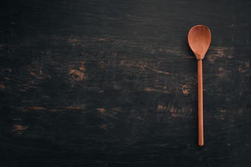 Wooden spoon Top view. On a wooden background. Free space for your text.