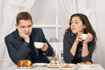 romantic couple drinking tea with cookies and talking