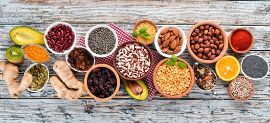 Superfoods Healthy food. Nuts, berries, fruits, and legumes. On a white wooden background. Top view. Free copy space.