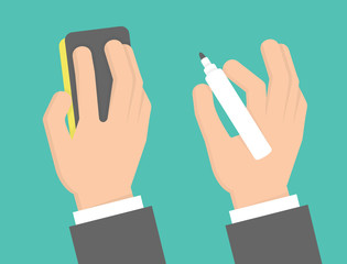 Hand holding marker and eraser sponge