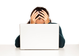 Frustrated young african woman at her laptop on white background