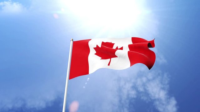 The Canadian flag waving in the wind on a sunny day.  Beautiful slow motion shot of the flag of Canada on a flagpole.