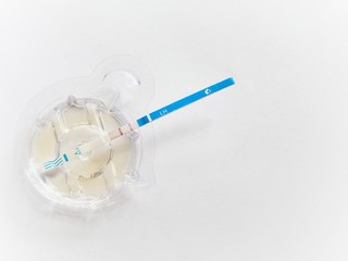 Ovulation test strip on white background.