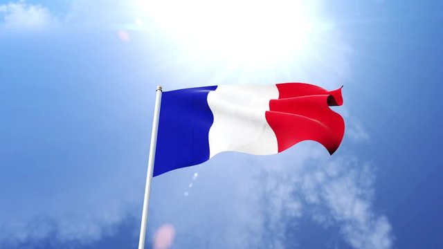 The French flag waving in the wind on a sunny day.  Beautiful slow motion shot of the national flag of France on a flagpole.