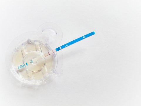 Ovulation test strip on white background.