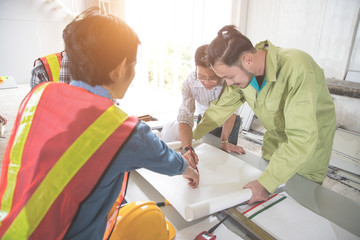 engineer people working and discussing with architecture or blueprint at construction site