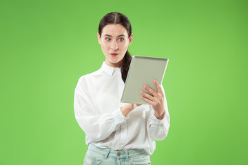 Businesswoman with laptop. Love to computer concept. Attractive female half-length front portrait, trendy green studio backgroud. Young emotional pretty woman. Human emotions, facial expression