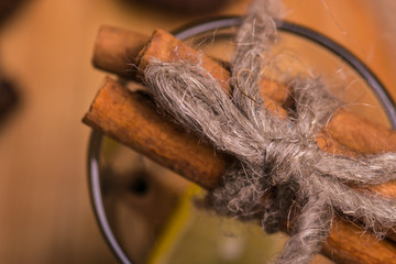 A glass with cinnamon and lemon.