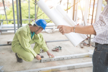 engineer people working and discussing with architecture or blueprint at construction site