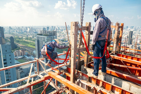 Construction worker wear standard personal protective equipment dismantle steel structure at height rise building project