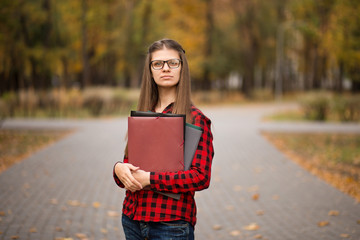 College student girl outdoors portrait. Smiling student girl