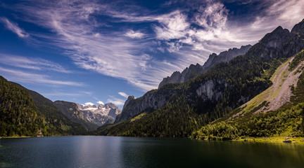 Idyllic, scenic view with dramatic clouds on Dachstein with glacier from Vorderer Gosausee in Alps, Austria 