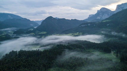 Fototapeta na wymiar Aerial view of the morning foggy landscape in the alpine mountains
