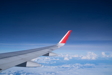 Fototapeta premium Beautiful view from airplane window and blue sky on nice sunny day, This time in altitude during flight.
