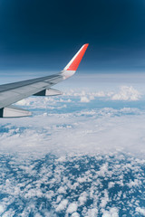 Beautiful view from airplane window and blue sky on nice sunny day, This time in altitude during flight.