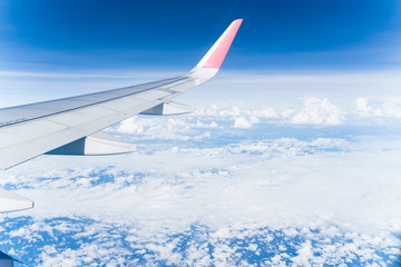 Beautiful view from airplane window and blue sky on nice sunny day, This time in altitude during flight.