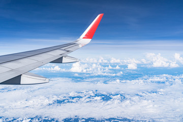 Beautiful view from airplane window and blue sky on nice sunny day, This time in altitude during flight.