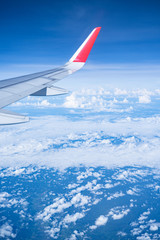 Beautiful view from airplane window and blue sky on nice sunny day, This time in altitude during flight.