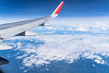 Beautiful view from airplane window and blue sky on nice sunny day, This time in altitude during flight.