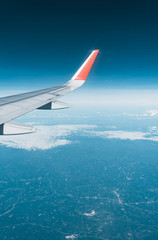 Fototapeta premium Beautiful view from airplane window and blue sky on nice sunny day, This time in altitude during flight.