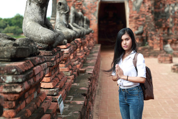 portrait of beautiful traveler asian woman paying respect in ancient temple