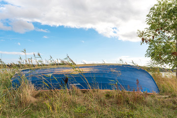 Rowing boat upside down on headland in the conservation area, in German Gobbiner Haken, on the Rügen island © ksl