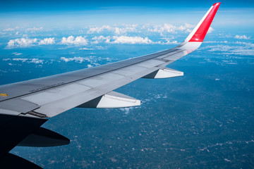 Beautiful view from airplane window and blue sky on nice sunny day, This time in altitude during flight.