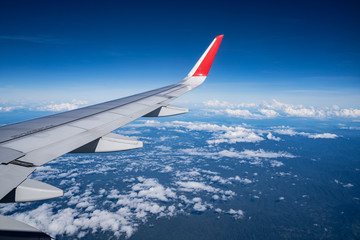 Fototapeta premium Beautiful view from airplane window and blue sky on nice sunny day, This time in altitude during flight.