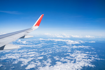 Beautiful view from airplane window and blue sky on nice sunny day, This time in altitude during flight.