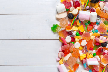 Colorful candies on wooden background