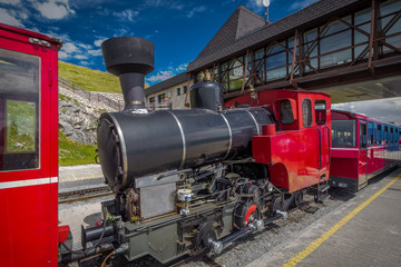 Red steam historic locomotive waiting in Schafbergspitze station near Salzburg, Upper Austria