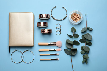 Composition with tropical leaves, makeup brushes and accessories on color background