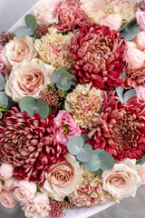 Beautiful spring bouquet in glass vase. Arrangement with various flowers. The concept of a flower shop. A set of photos for a site or catalogue. Work florist.