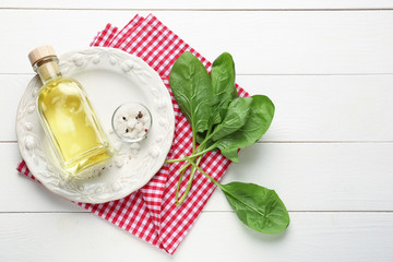Fresh aromatic sorrel with spices and oil on white wooden table