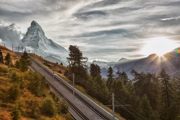 Photo sur Plexiglas Cervin Matterhorn peak with railway against sunset in Swiss Alps, Switzerland