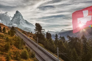 Tableaux sur verre Cervin Matterhorn peak with railway against sunset in Swiss Alps, Switzerland