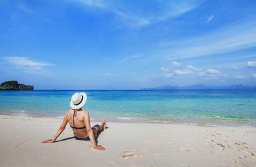 Vacation on paradise white sand beach, tropical holidays travel,  woman tourist  relaxing near turquoise sea.