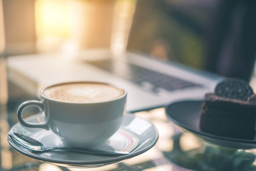 Latte coffee or coffe on the table of cafe in the morning  