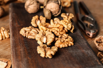 Shelled walnuts on wooden board, closeup