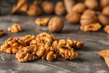Shelled walnuts on grey table