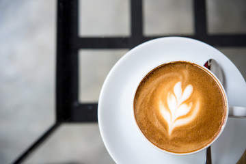 Latte coffee or coffe on the table of cafe in the morning  