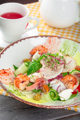 Fresh seafood salad served with prawns and greens