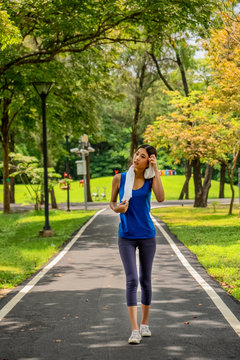 Asian Young Girl Relaxing After Jogging In Park