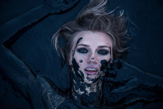 Portrait of Blonde Lays Smeared in a Healthy Black Mud