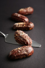 Delicious eclairs on grey background