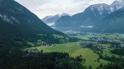 Aerial view of the morning foggy landscape in the alpine mountains